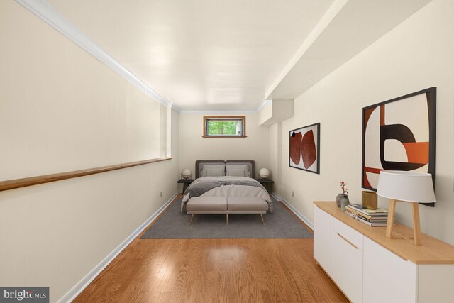 unfurnished bedroom featuring crown molding and hardwood / wood-style floors