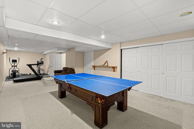 rec room featuring light colored carpet and a paneled ceiling