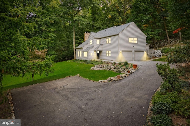 view of property with a front lawn and a garage