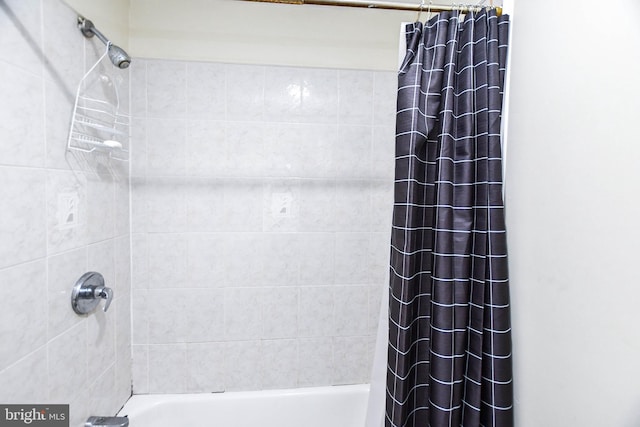 bathroom with shower / tub combo with curtain