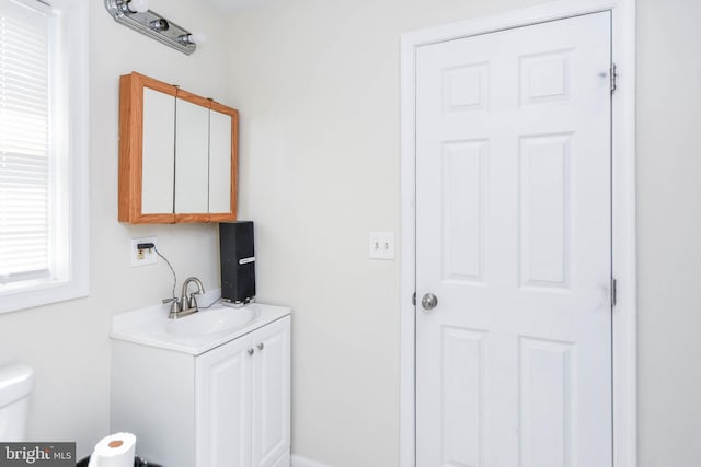 bathroom featuring vanity and toilet