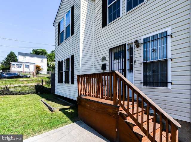 wooden deck featuring a lawn