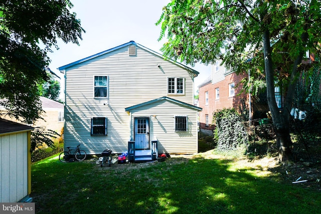 back of house with a lawn