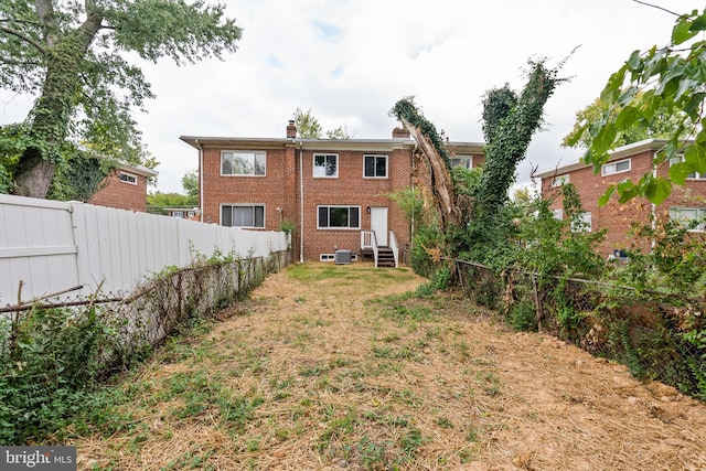 rear view of property with central air condition unit