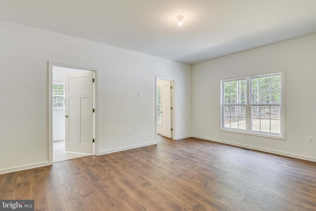 spare room with wood-type flooring