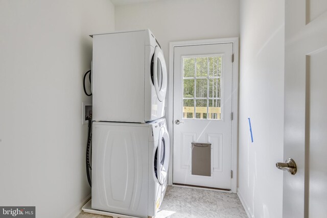 laundry area with stacked washer and clothes dryer