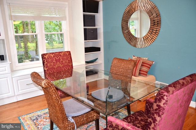 dining space with wood-type flooring