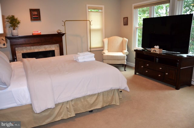 carpeted bedroom featuring a fireplace