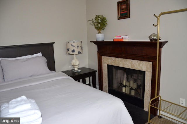 bedroom with a tile fireplace