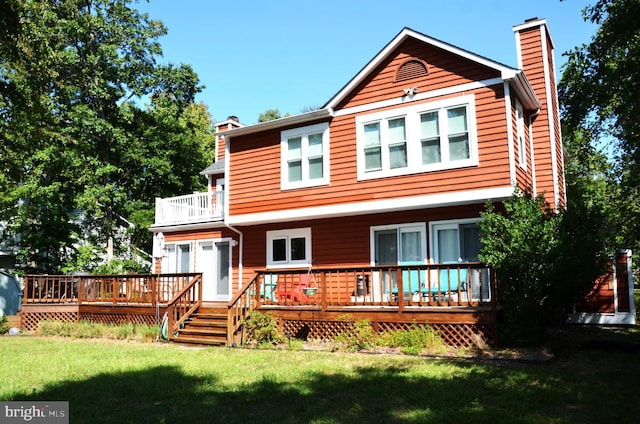 back of house with a deck and a lawn