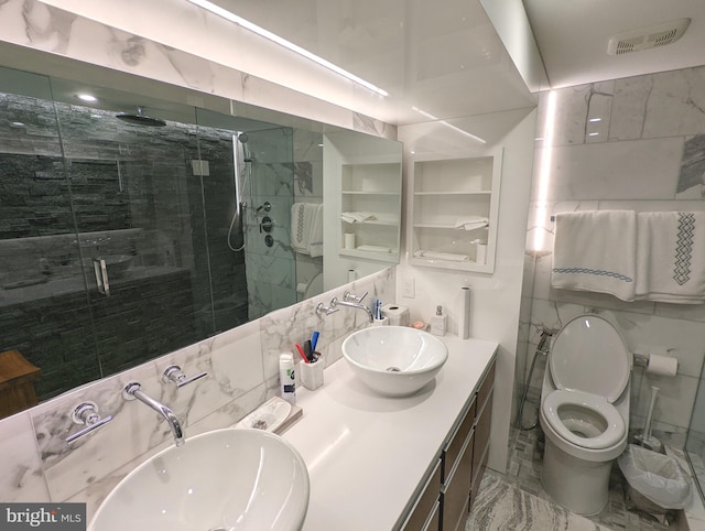 bathroom with vanity, tasteful backsplash, a shower with shower door, tile walls, and toilet