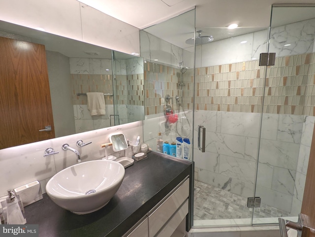 bathroom with vanity and a shower with shower door