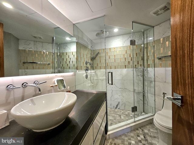 bathroom featuring visible vents, a shower stall, vanity, toilet, and recessed lighting
