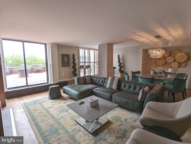 living room featuring a notable chandelier and hardwood / wood-style flooring