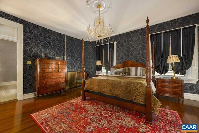 bedroom featuring a notable chandelier and dark hardwood / wood-style flooring