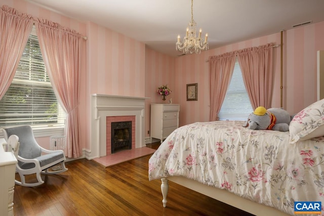 bedroom with an inviting chandelier and wood-type flooring