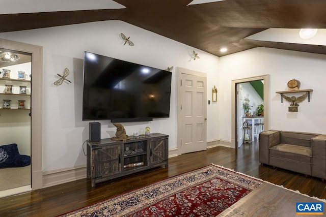 living room featuring lofted ceiling and dark hardwood / wood-style flooring