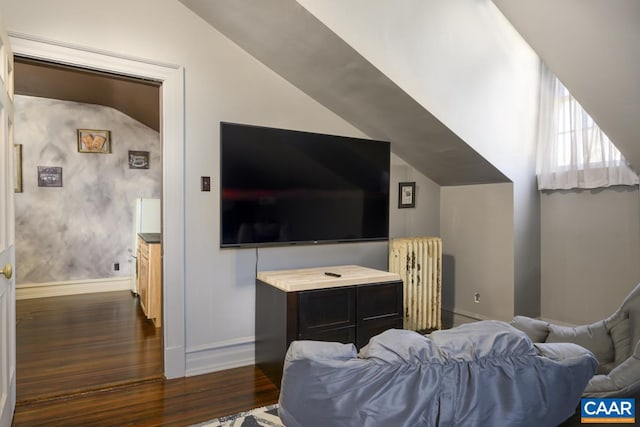 living room featuring radiator, vaulted ceiling, and dark wood-type flooring