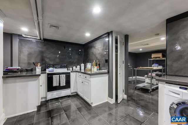 kitchen featuring decorative backsplash, white cabinets, washer / dryer, dark tile patterned floors, and white range with electric cooktop