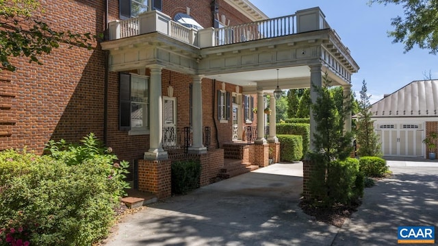 property entrance featuring a balcony and a garage