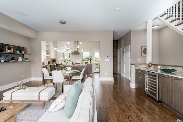 dining room with wine cooler, bar, and dark hardwood / wood-style flooring