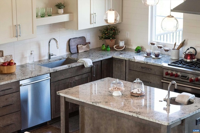 kitchen with hanging light fixtures, stainless steel dishwasher, extractor fan, and tasteful backsplash