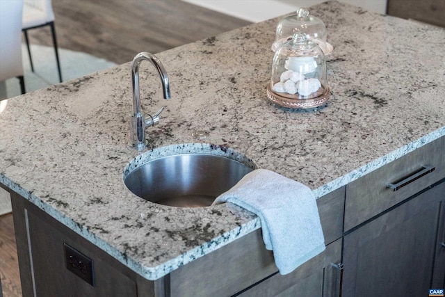 room details featuring sink and light stone counters