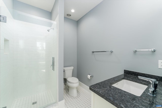 bathroom with vanity, toilet, and a shower with door