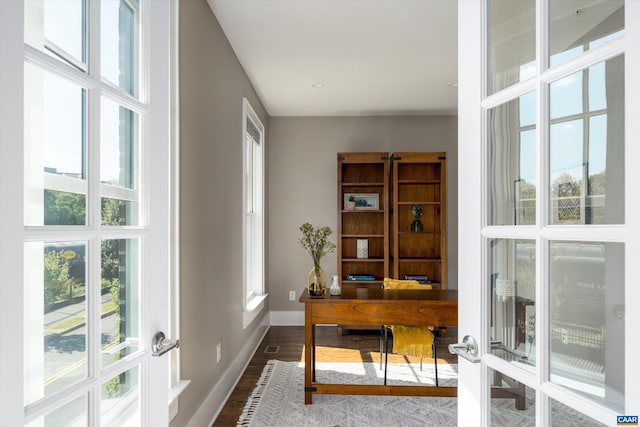 office space featuring french doors and hardwood / wood-style flooring