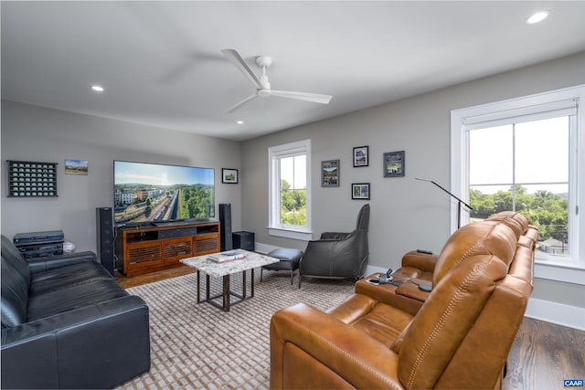 living room featuring ceiling fan, hardwood / wood-style floors, and a wealth of natural light