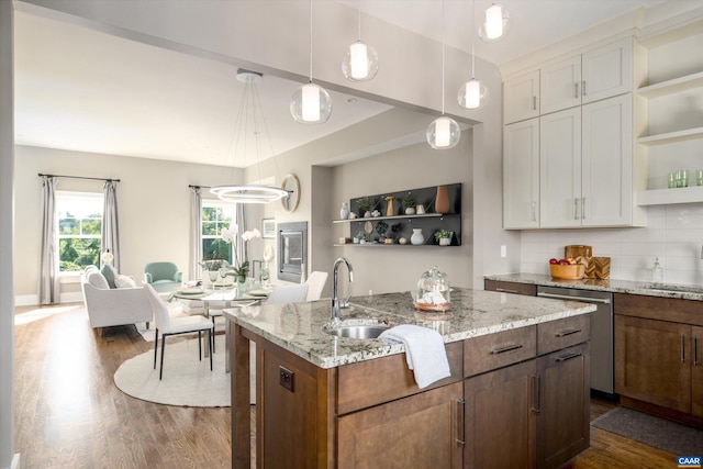 kitchen featuring dishwasher, a kitchen island with sink, dark wood-type flooring, and white cabinetry