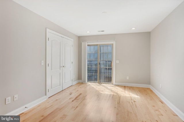 unfurnished room with light hardwood / wood-style floors