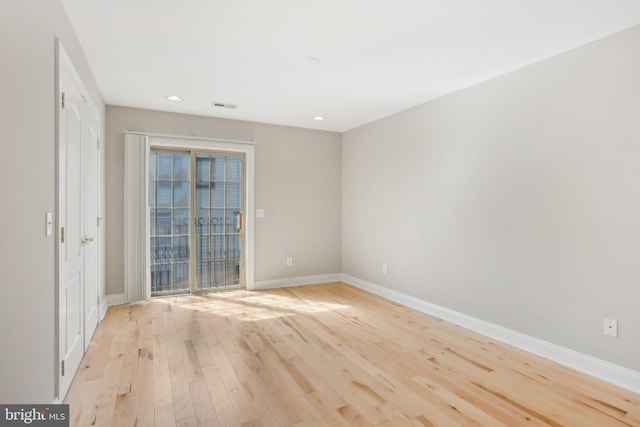 spare room with light hardwood / wood-style flooring