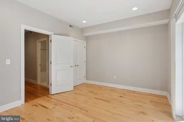 unfurnished bedroom with hardwood / wood-style floors