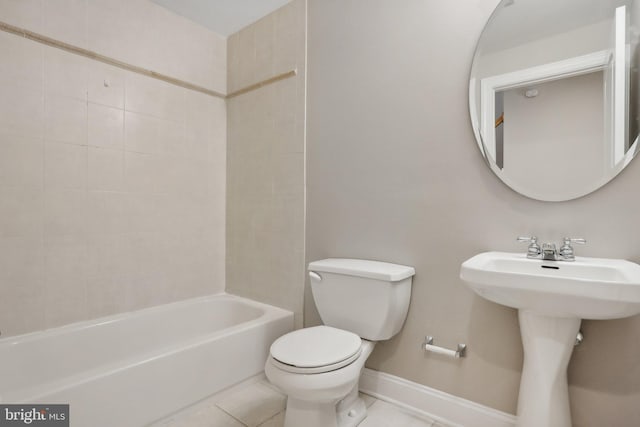 full bathroom featuring tile patterned flooring, sink, tiled shower / bath, and toilet