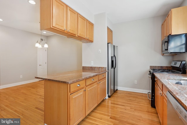 kitchen featuring light stone counters, stainless steel appliances, light hardwood / wood-style floors, and kitchen peninsula