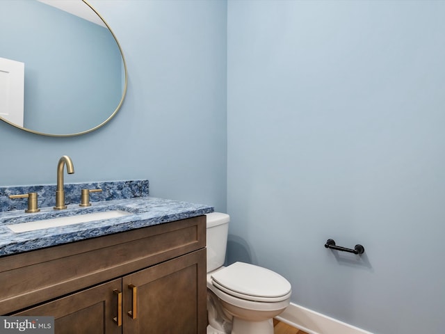 bathroom with toilet and vanity