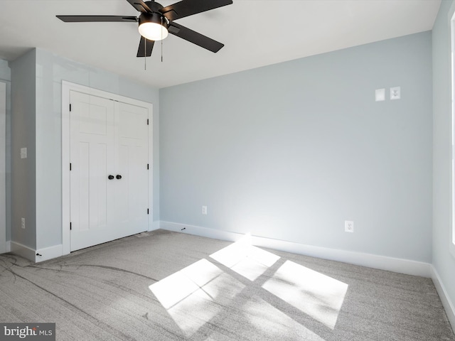 unfurnished bedroom featuring a closet, ceiling fan, and light carpet