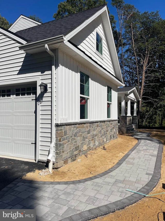 view of side of home with a garage