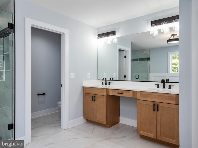 bathroom featuring vanity, toilet, and an enclosed shower