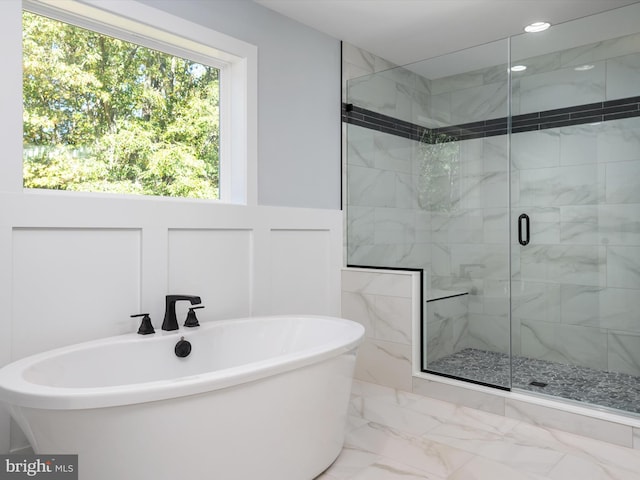 bathroom with shower with separate bathtub