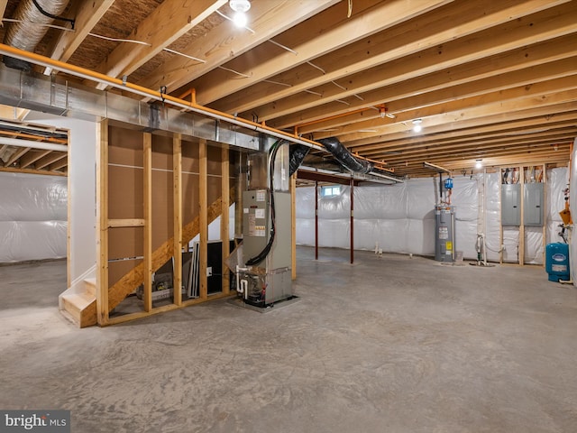 basement featuring electric panel, electric water heater, and heating unit