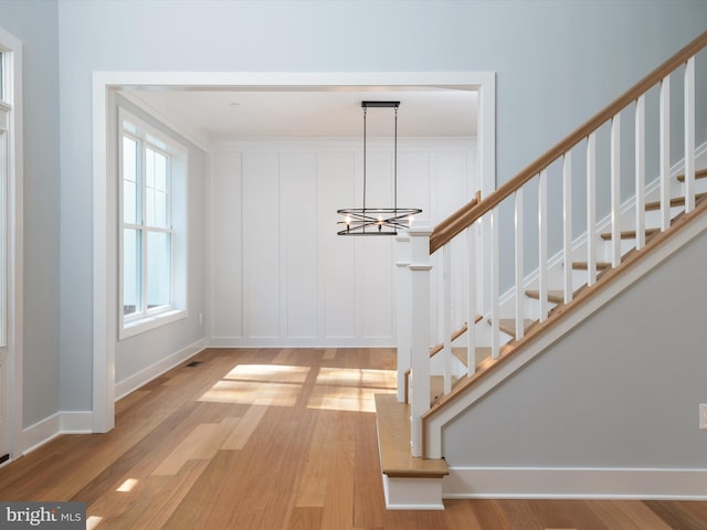 interior space featuring wood-type flooring and an inviting chandelier