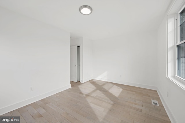 spare room featuring light hardwood / wood-style floors