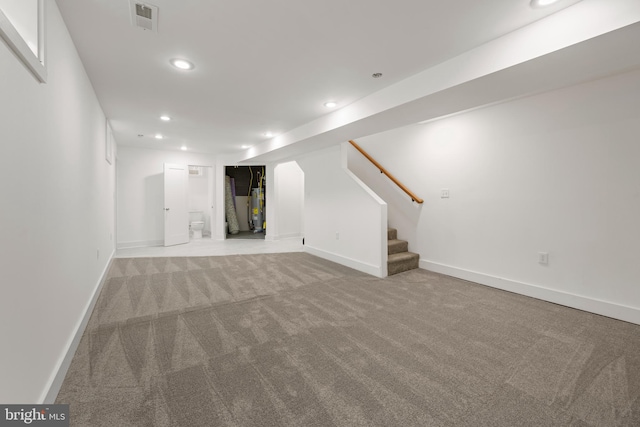 unfurnished living room with water heater and light colored carpet