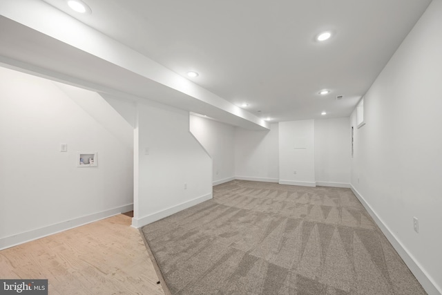 basement featuring light colored carpet