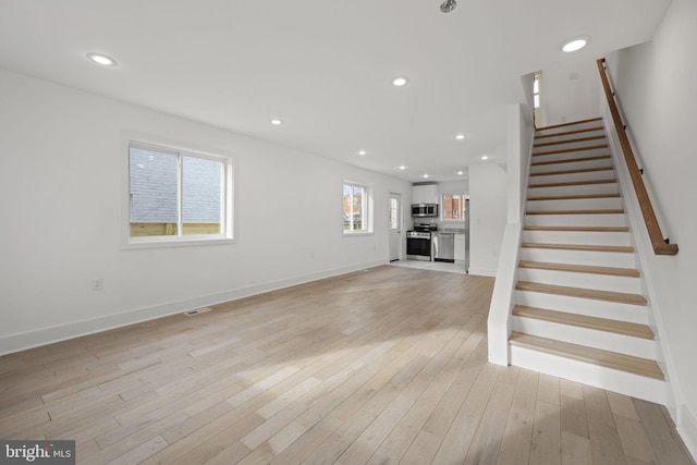 unfurnished living room featuring light hardwood / wood-style flooring