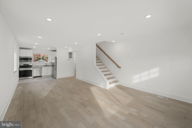 unfurnished living room with light wood-type flooring