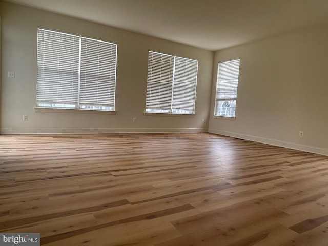 unfurnished room with light wood-type flooring