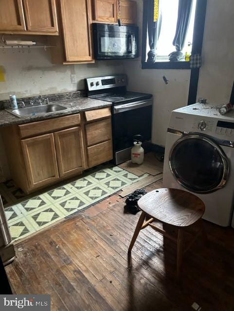 kitchen featuring electric stove, washer / clothes dryer, light hardwood / wood-style flooring, and sink